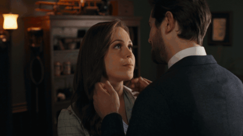 a man and woman are touching each other 's faces