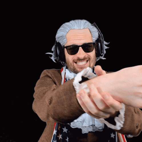 A sunglasses-wearing older man reaches out for a high five that is left hanging.