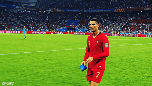 a soccer player with the number 7 on his jersey walks across the field