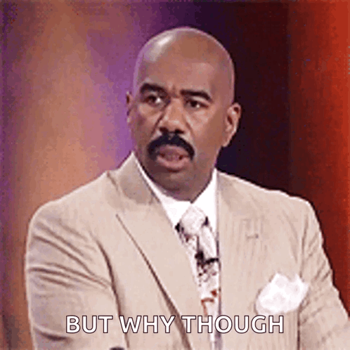 a bald man in a suit and tie is making a funny face and saying but why though .