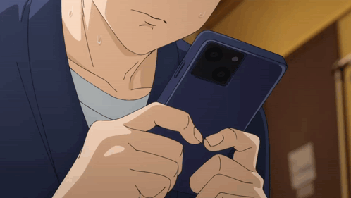 a man is holding a cell phone in his hands