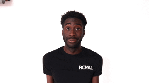 A man in a black T-shirt gives an uncertain look on a white background.