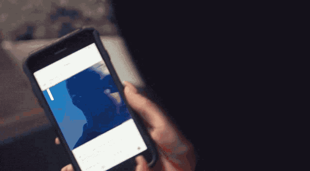a close up of a person holding a cell phone
