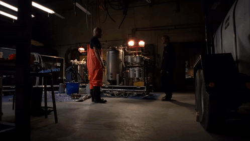 a man standing in a dark room with the words " you 're not leaving " below him