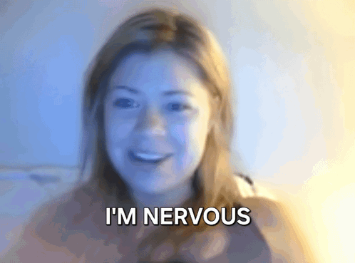 A woman smiles nervously in a dreamy blue-lit close-up with the caption “I'M NERVOUS.”
