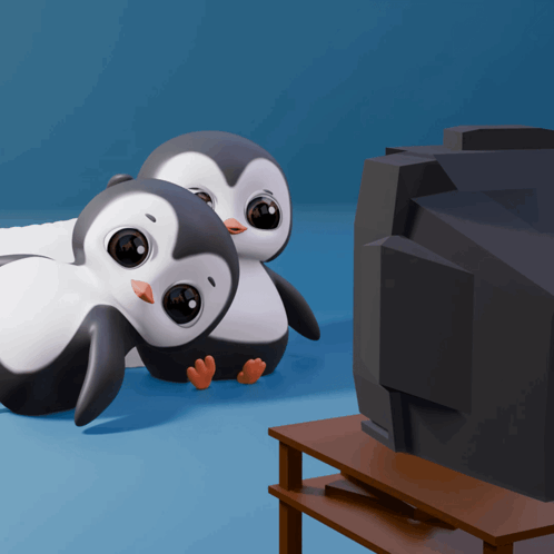 two penguins are sitting in front of a television on a shelf