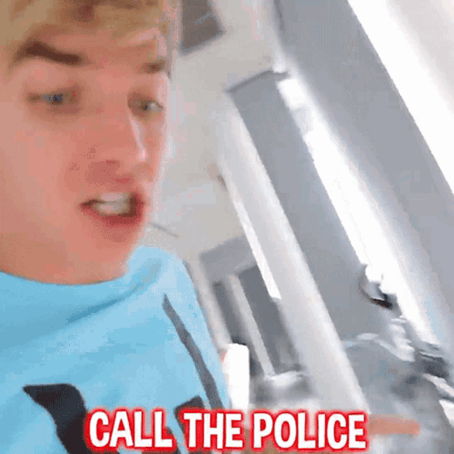 a man in a blue shirt is saying " call the police "