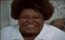 A woman squeezes her eyes shut in an intense excited expression.