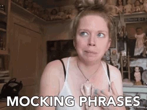 a woman says mocking phrases in front of dolls