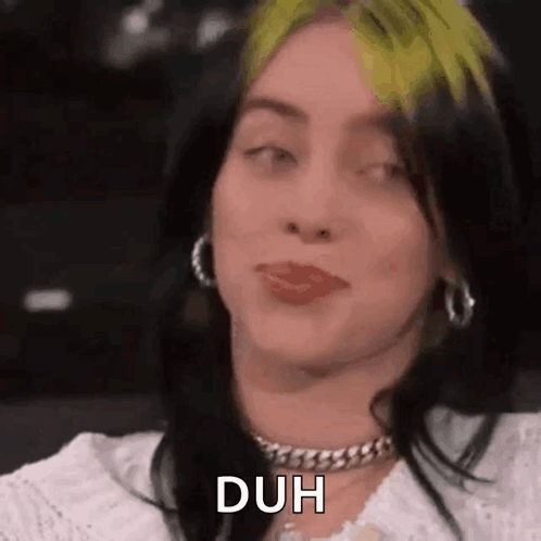 Billie Eilish glances sideways with her tongue slightly out, captioned “DUH”.