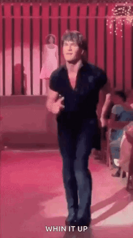 a man is dancing on a stage with the words `` whin it up '' written next to him .