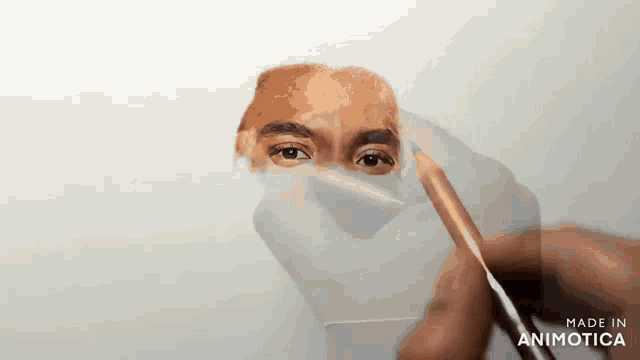 a drawing of a man 's face is being made in animatica
