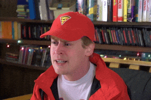 a man wearing a red hat that has a pizza on it
